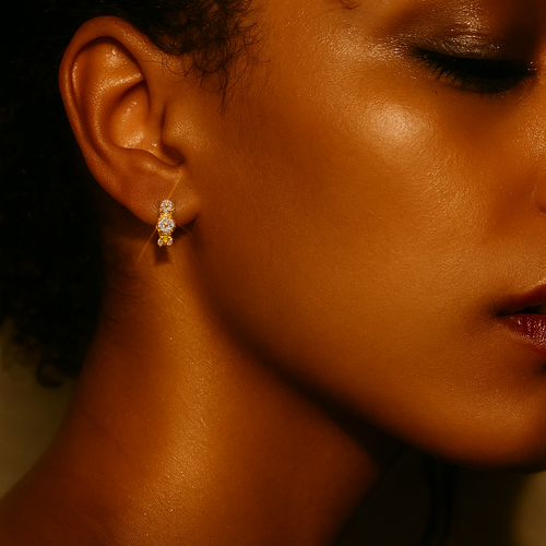 Close-up of a woman wearing a gold earring with diamond.