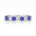 Platinum ring with tanzanite gemstones and lab grown diamonds on a white background